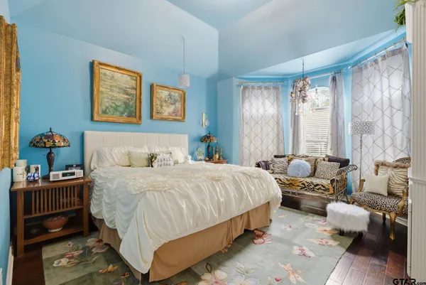 a dining room with furniture and wooden floor
