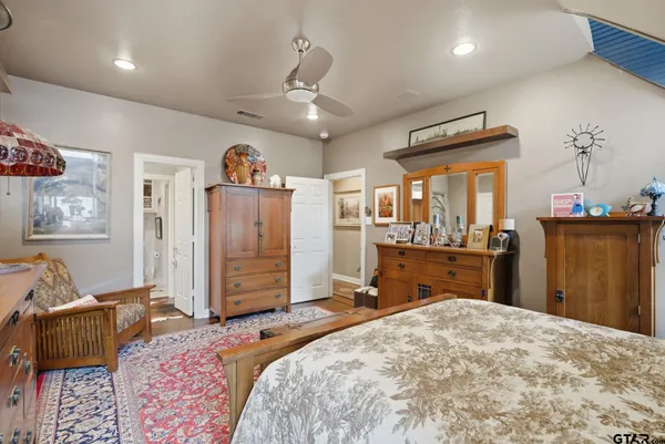 a bedroom with a bed and wooden furniture