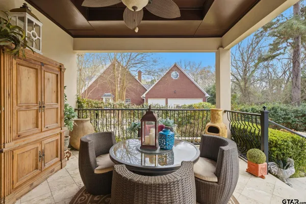 a living room with a large window and furniture