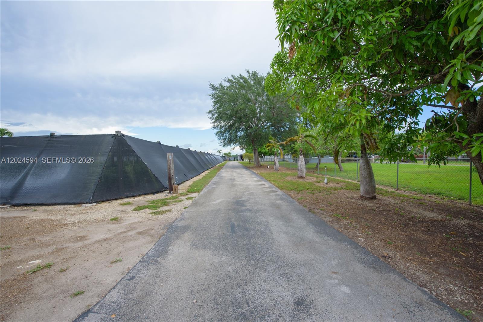17355 Southwest 256th Street Homestead, FL 33031 - Photo 29 of 32 a view of a road with a yard