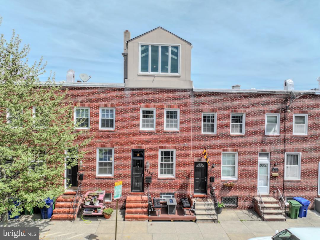 front view of a brick house with a yard