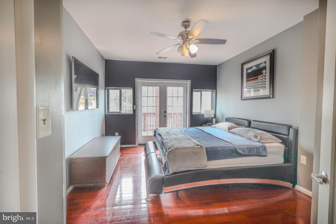 1139 Scott Street Baltimore, MD 21230 - Photo 25 of 60 a bedroom with a large bed and a chandelier