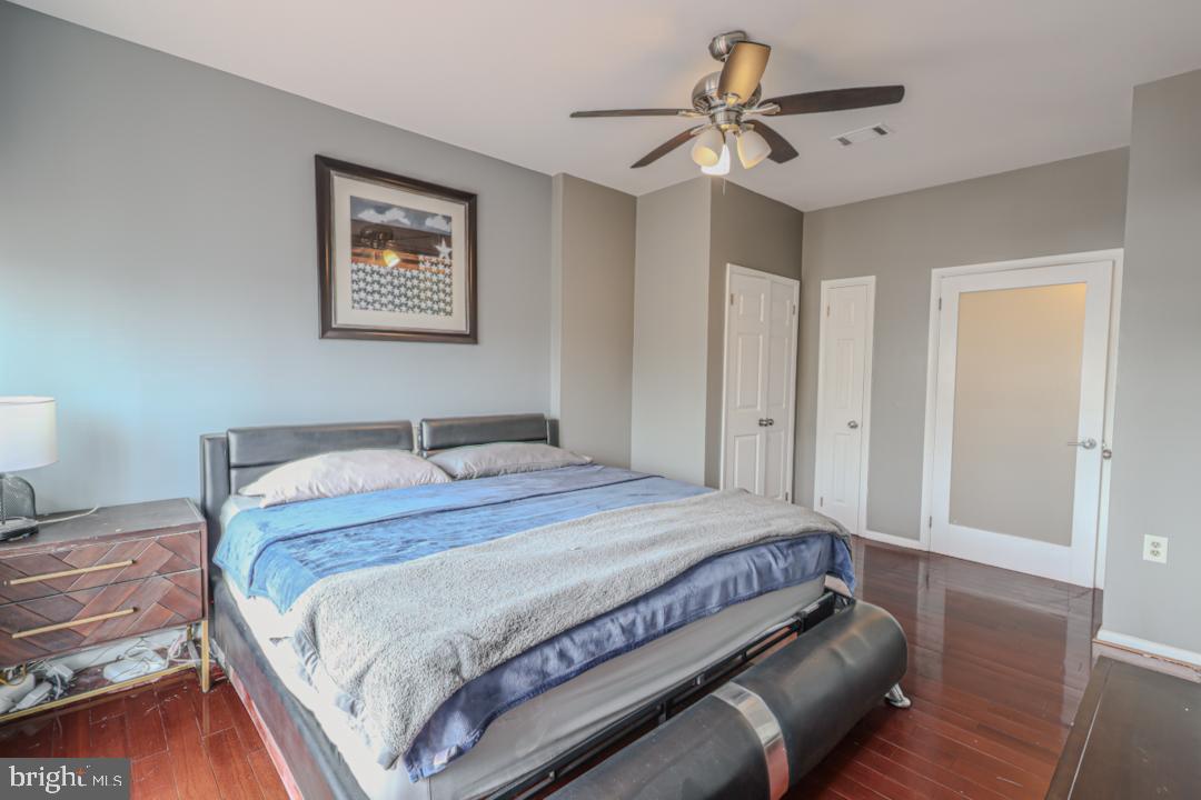 1139 Scott Street Baltimore, MD 21230 - Photo 27 of 60 a bedroom with a bed and a chandelier