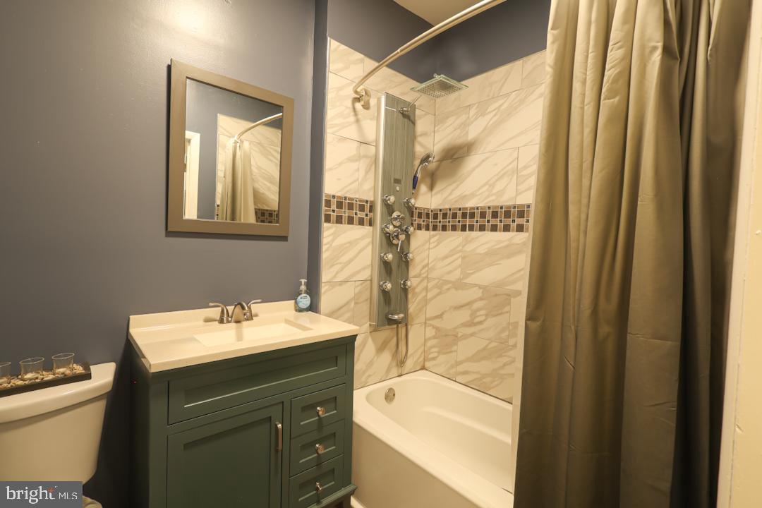 1139 Scott Street Baltimore, MD 21230 - Photo 29 of 60 a bathroom with a sink and a mirror