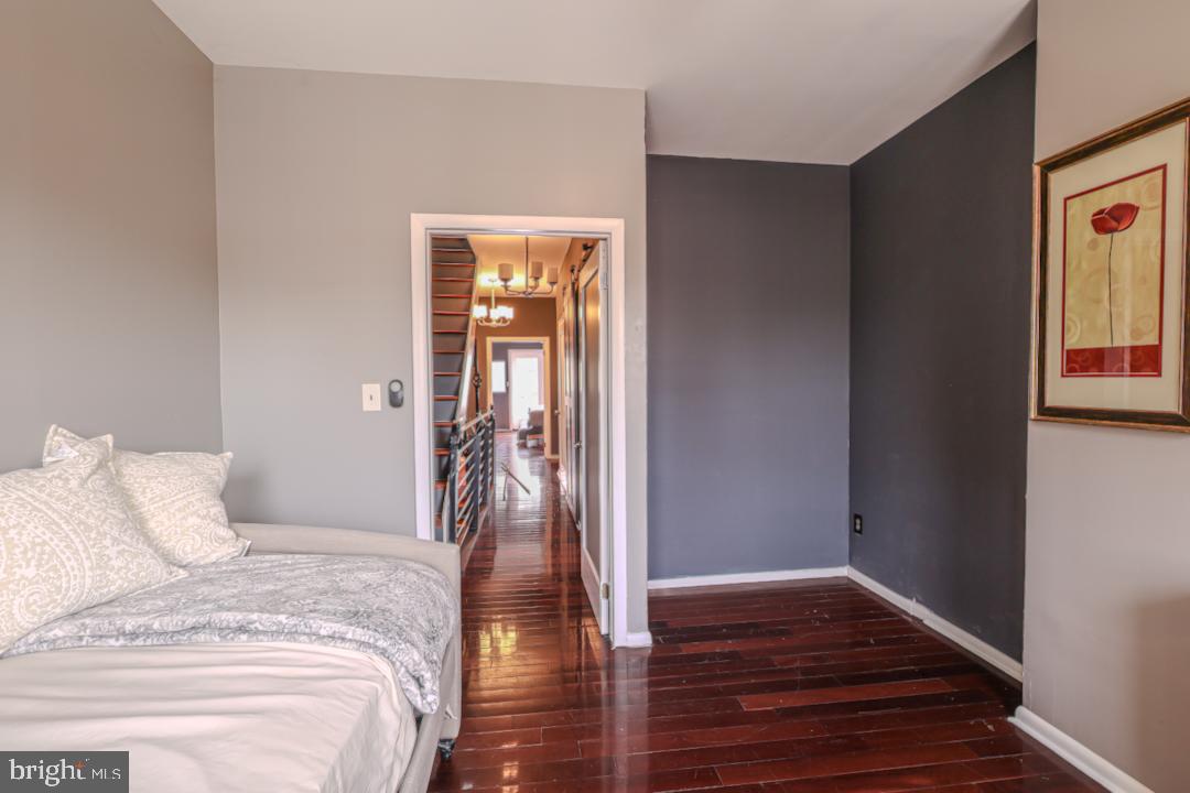 1139 Scott Street Baltimore, MD 21230 - Photo 32 of 60 a bedroom with a bed and wooden floor