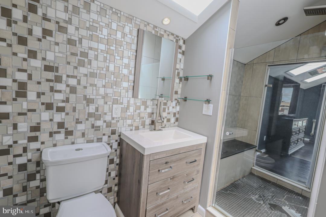 1139 Scott Street Baltimore, MD 21230 - Photo 36 of 60 a bathroom with a sink a toilet and shower