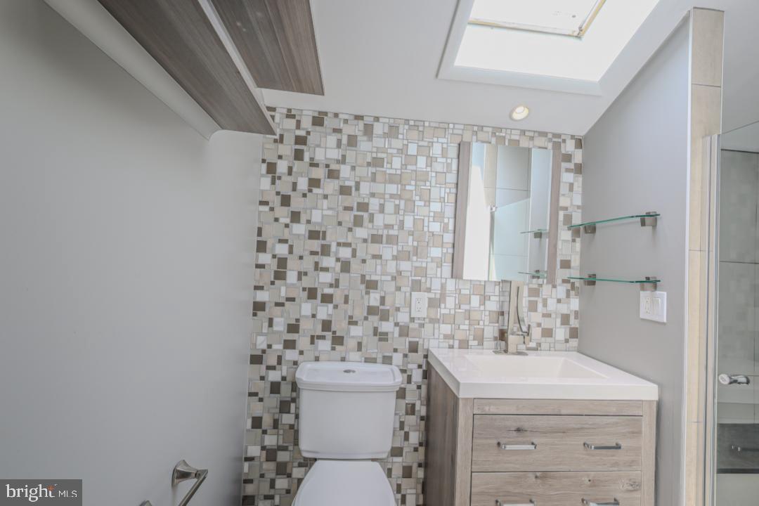 1139 Scott Street Baltimore, MD 21230 - Photo 37 of 60 a bathroom with a sink toilet and a mirror
