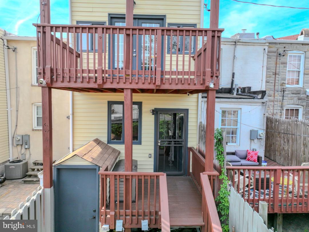 1139 Scott Street Baltimore, MD 21230 - Photo 51 of 60 a view of a house with a wooden fence