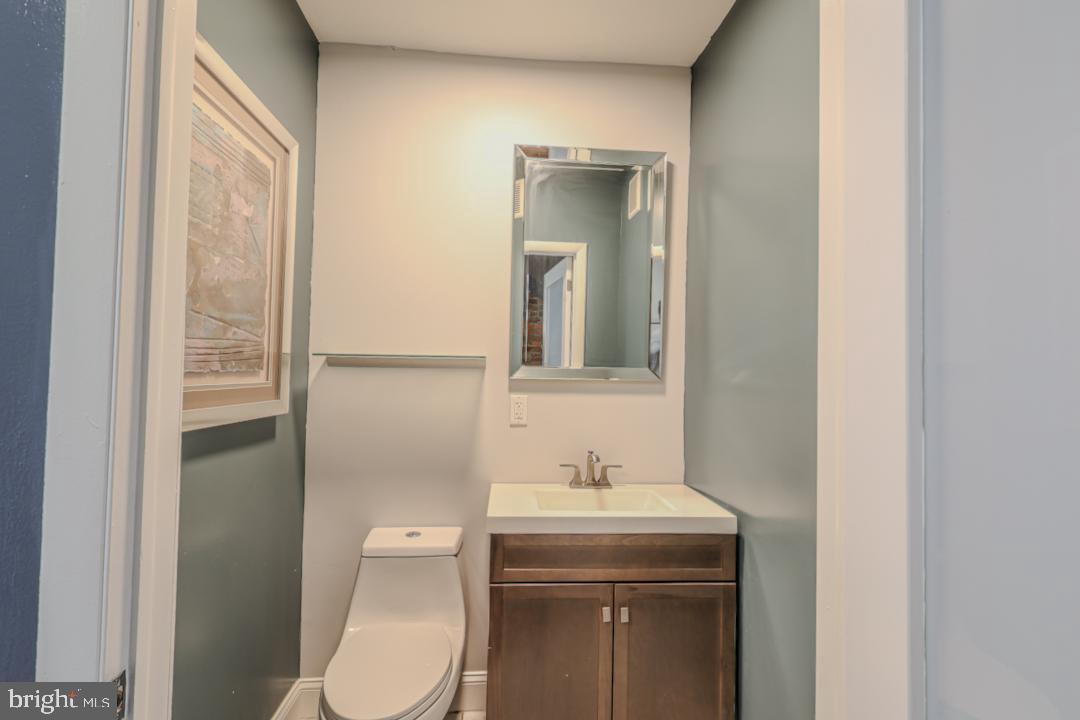 1139 Scott Street Baltimore, MD 21230 - Photo 9 of 60 a bathroom with a toilet a sink and mirror