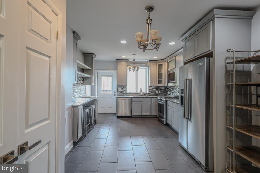 1139 Scott Street Baltimore, MD 21230 - Photo 10 of 60 a large kitchen with cabinets and stainless steel appliances