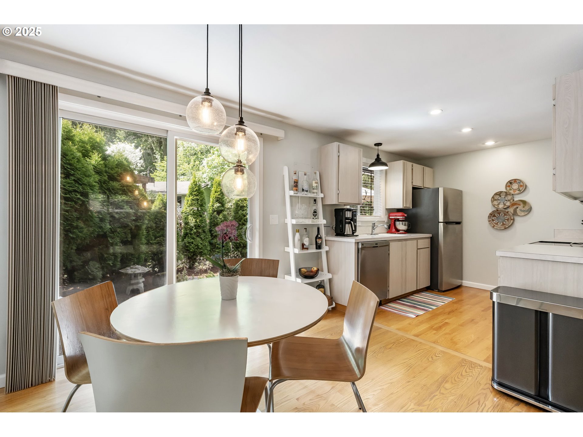 4560 Northwest Barnes Road Portland, OR 97210 - Photo 12 of 36 a kitchen with kitchen island stainless steel appliances a dining table chairs and sink