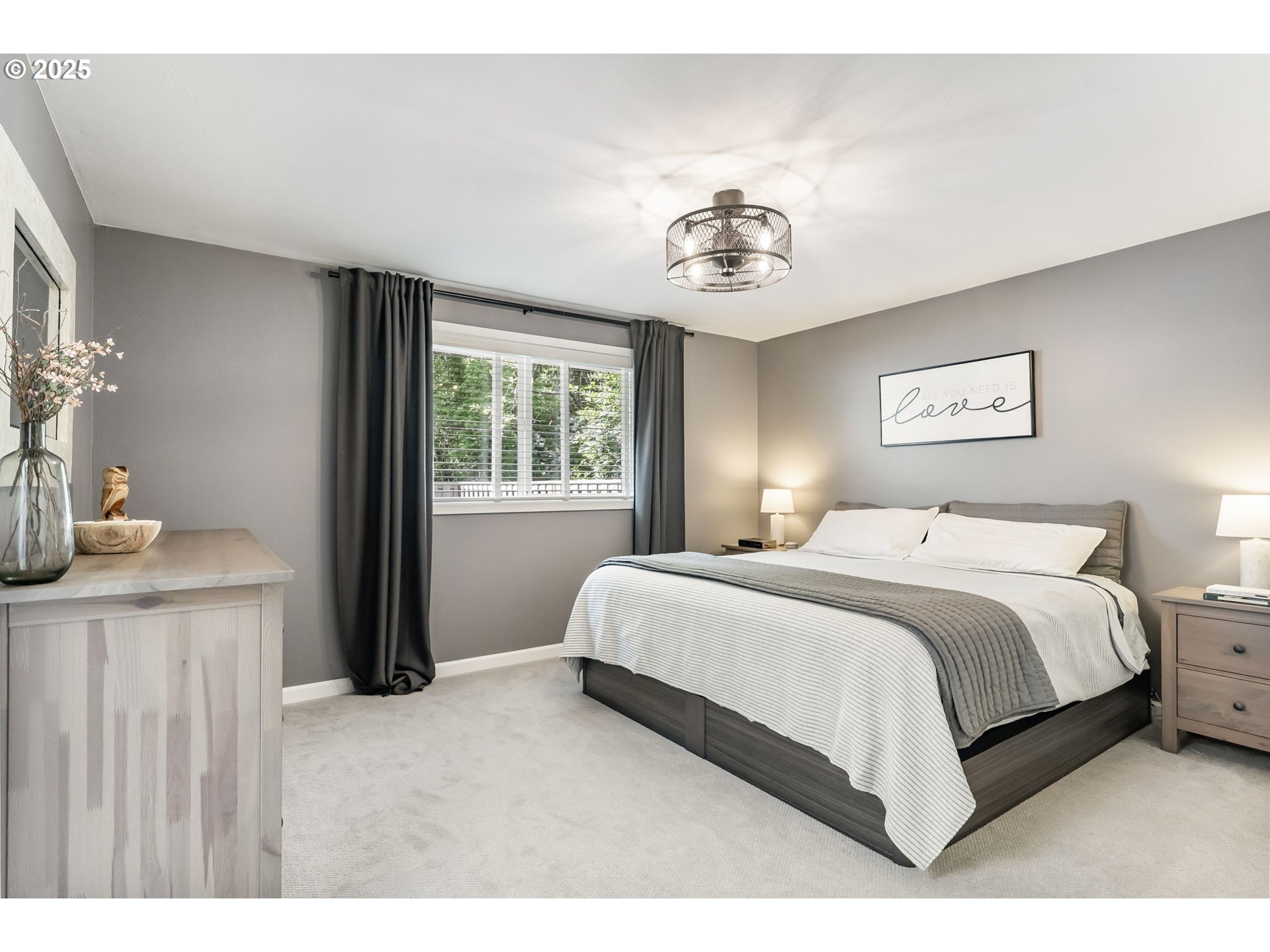 4560 Northwest Barnes Road Portland, OR 97210 - Photo 17 of 36 a bedroom with a bed and a chandelier