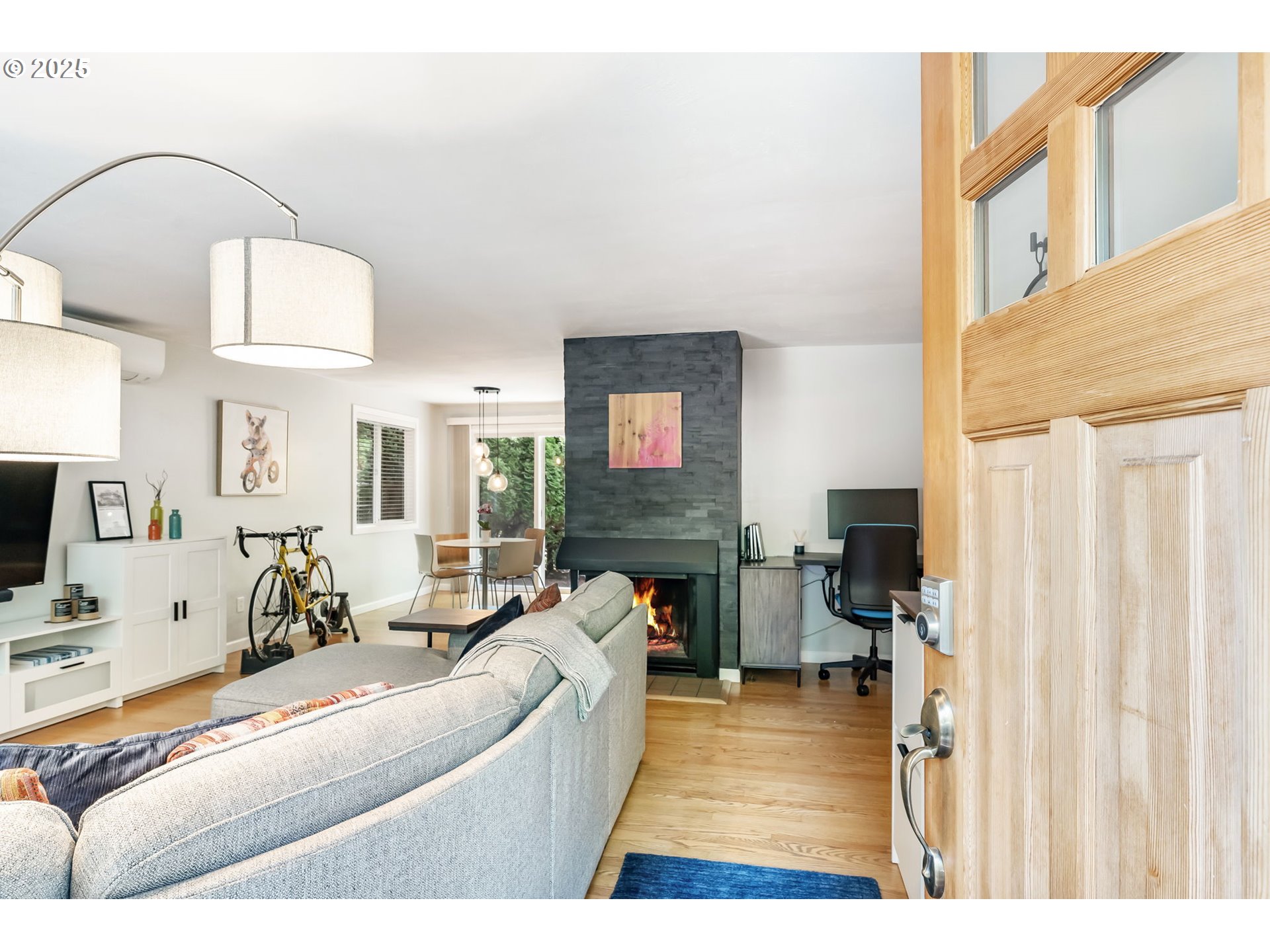 4560 Northwest Barnes Road Portland, OR 97210 - Photo 2 of 36 a living room with furniture a flat screen tv and a fireplace