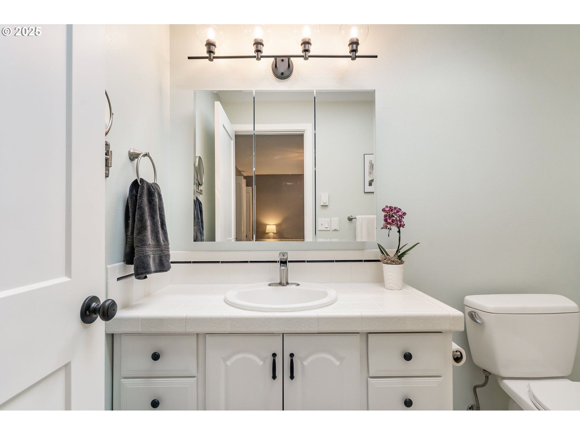 4560 Northwest Barnes Road Portland, OR 97210 - Photo 23 of 36 a bathroom with a sink and a mirror