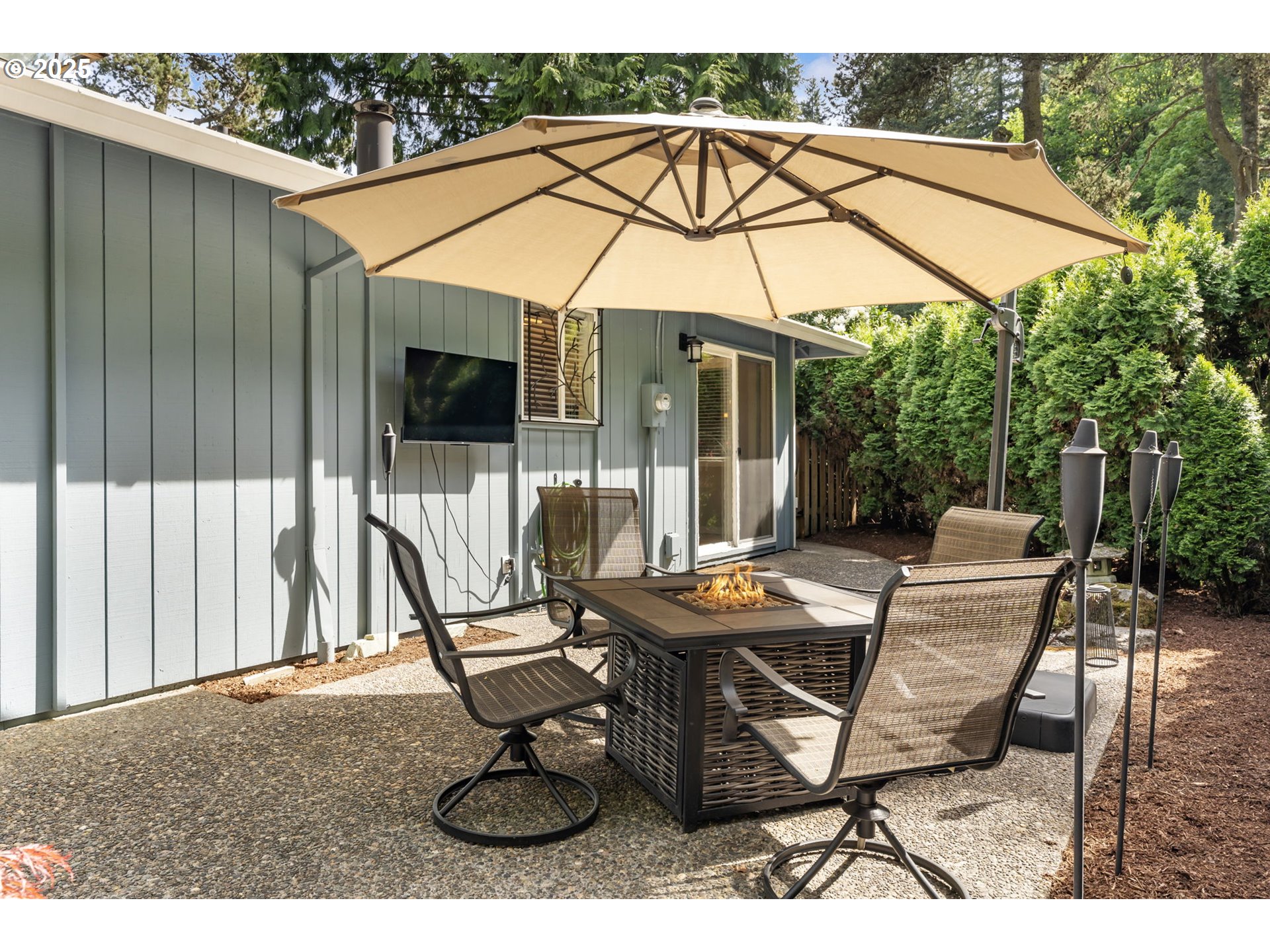 4560 Northwest Barnes Road Portland, OR 97210 - Photo 27 of 36 a patio with a yard table and chairs