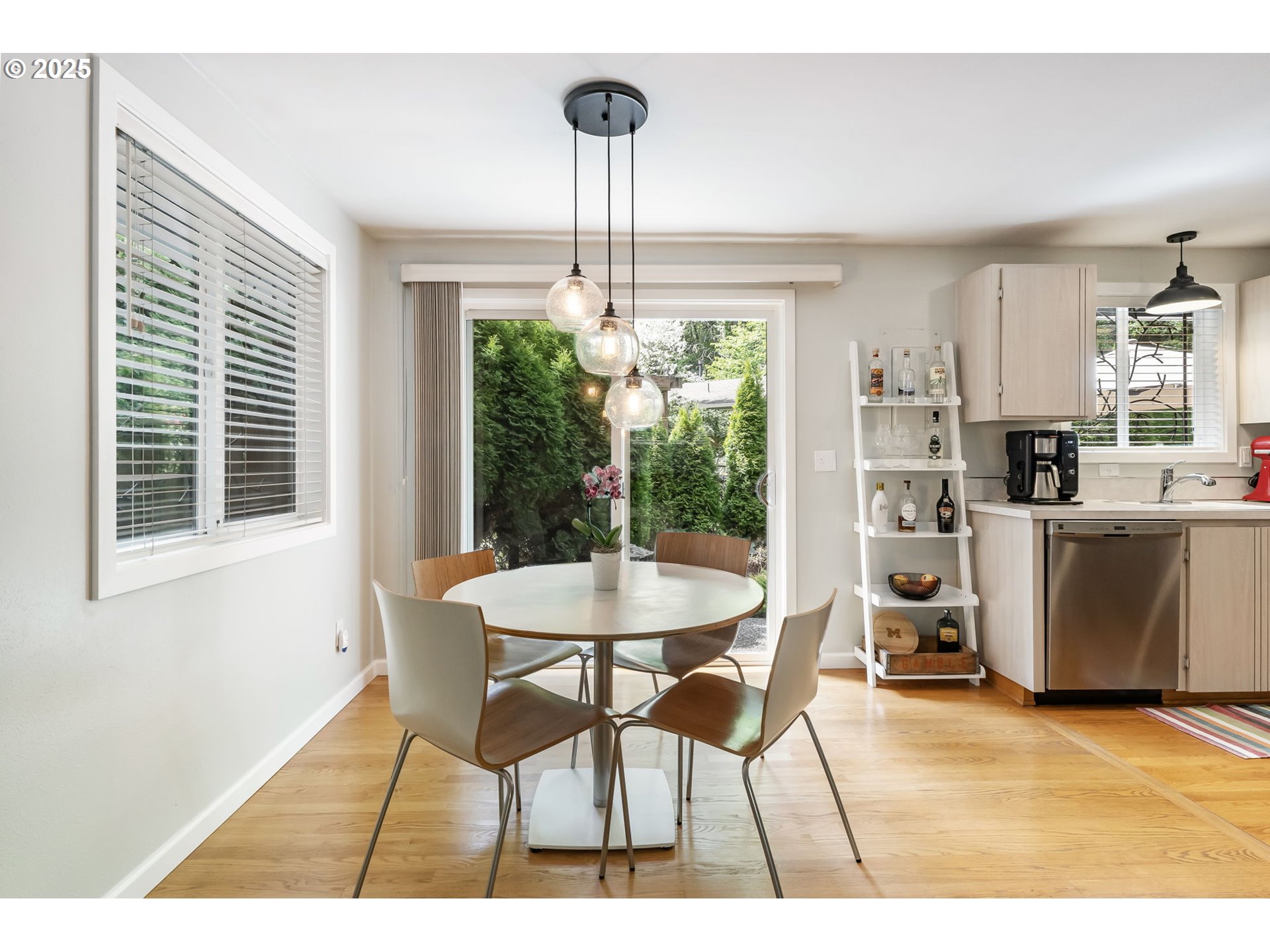 4560 Northwest Barnes Road Portland, OR 97210 - Photo 7 of 36 a dining room with furniture and a chandelier