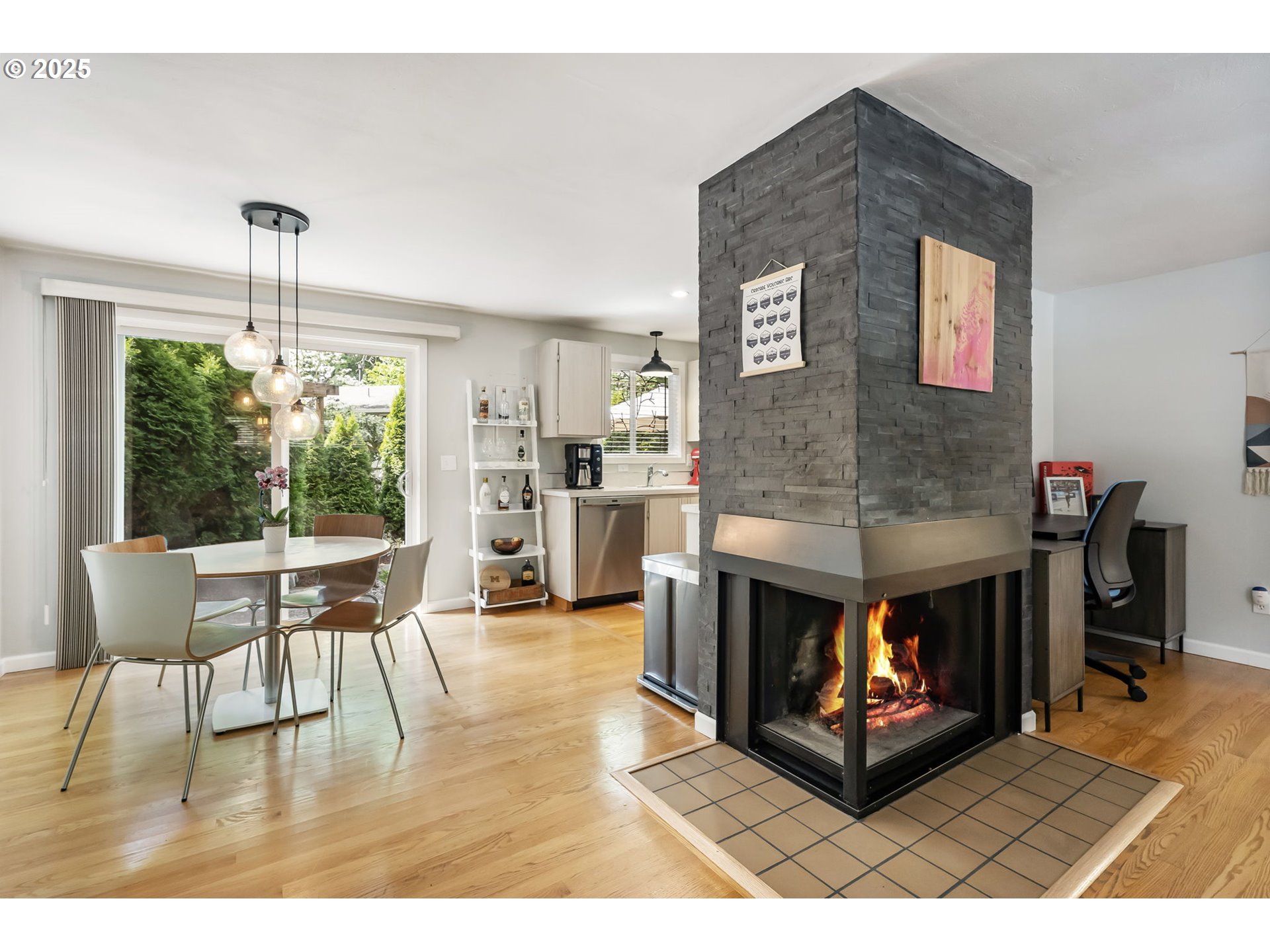 4560 Northwest Barnes Road Portland, OR 97210 - Photo 8 of 36 a living room with furniture a fireplace and a dining table