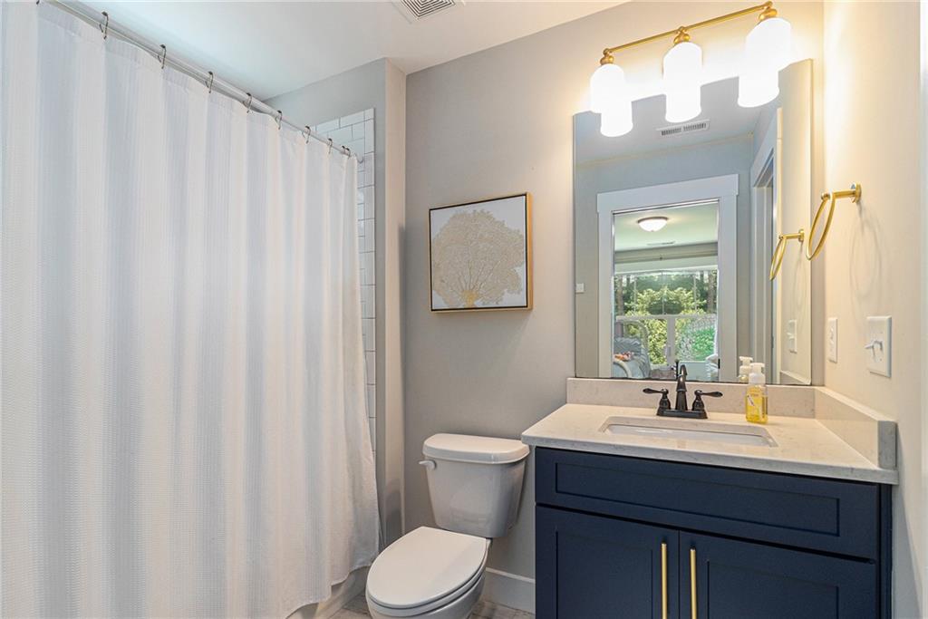 1229 Dean Hill Road Southeast Monroe, GA 30655 - Photo 29 of 51 a bathroom with a sink a toilet and a mirror