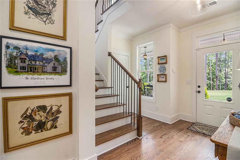1229 Dean Hill Road Southeast Monroe, GA 30655 - Photo 4 of 51 a view of a hallway with wooden floor and a workspace