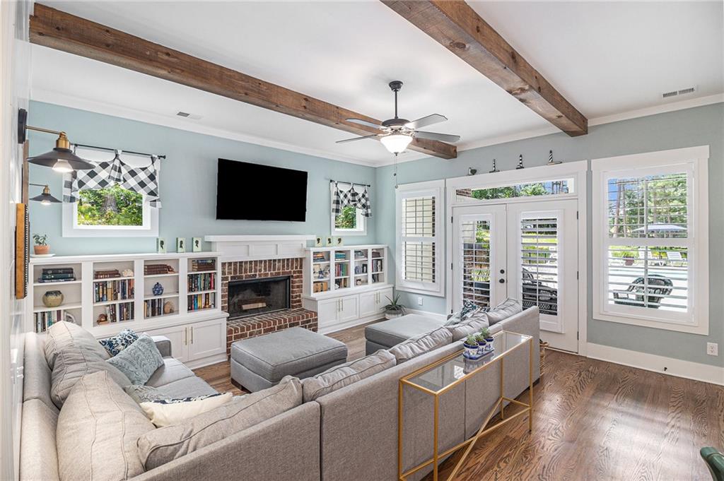 1229 Dean Hill Road Southeast Monroe, GA 30655 - Photo 6 of 51 a living room with furniture a flat screen tv and a fireplace