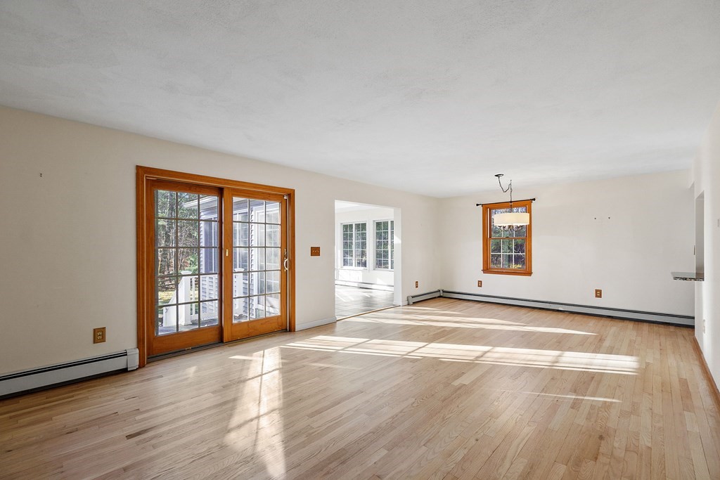 462 Lowell Road Groton, MA 01450 - Photo 12 of 42 a view of an empty room with wooden floor and a window