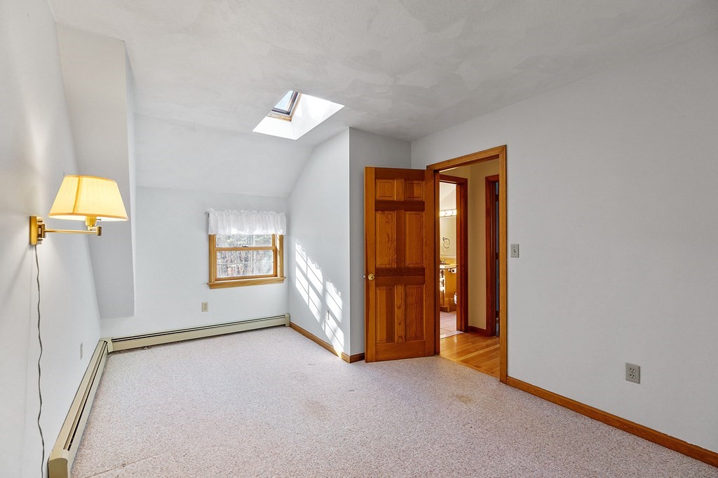462 Lowell Road Groton, MA 01450 - Photo 20 of 42 an empty room with a window and a ceiling fan