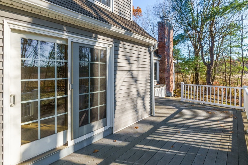 462 Lowell Road Groton, MA 01450 - Photo 24 of 42 a porch with a bench next to a yard