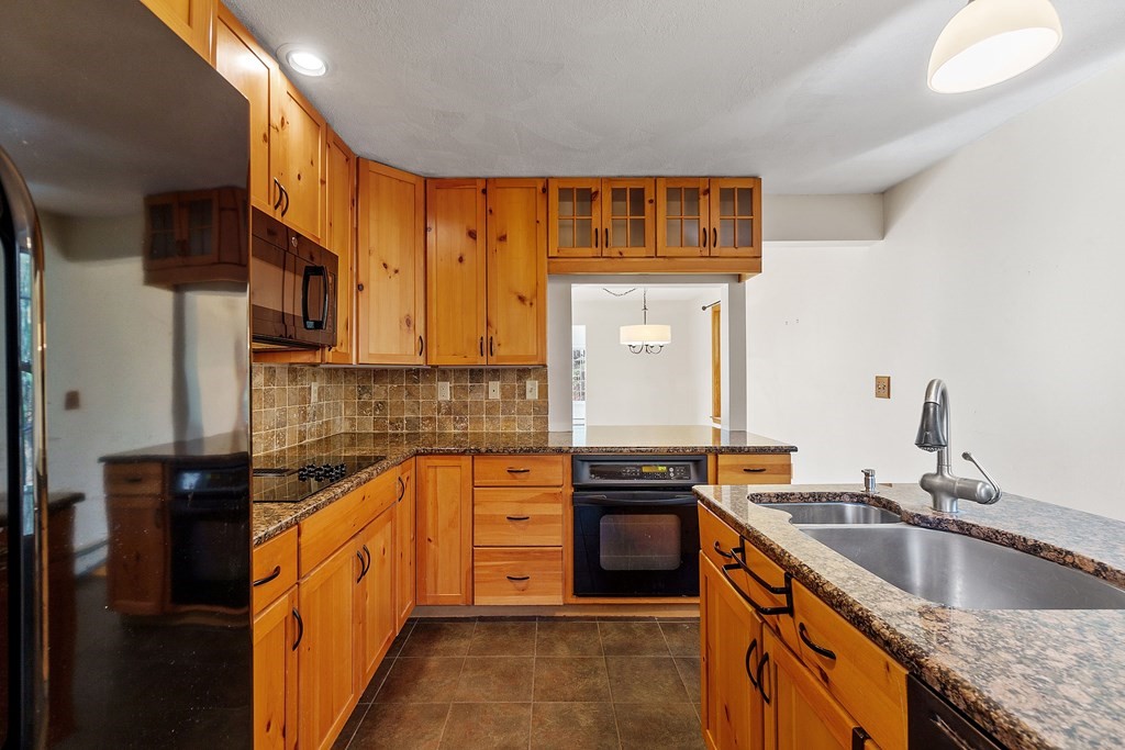462 Lowell Road Groton, MA 01450 - Photo 6 of 42 a kitchen with stainless steel appliances granite countertop a sink stove and refrigerator