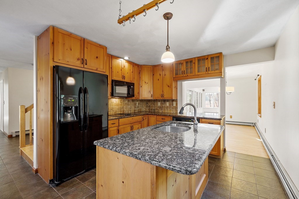 462 Lowell Road Groton, MA 01450 - Photo 7 of 42 a kitchen with stainless steel appliances granite countertop a sink refrigerator and cabinets