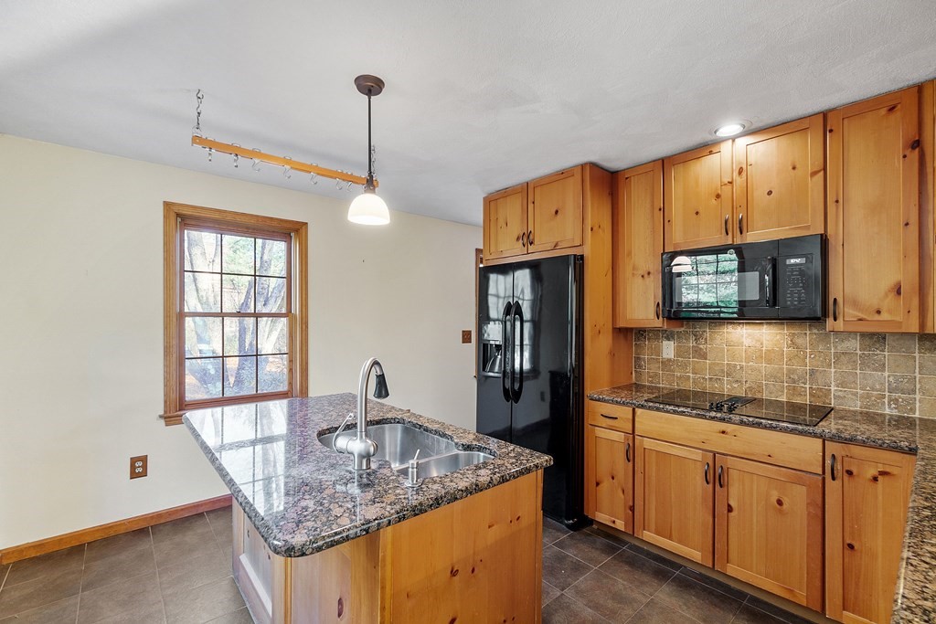 462 Lowell Road Groton, MA 01450 - Photo 8 of 42 a kitchen with stainless steel appliances granite countertop a sink refrigerator and microwave