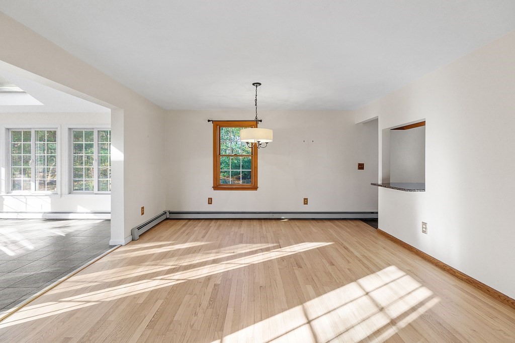462 Lowell Road Groton, MA 01450 - Photo 9 of 42 a view of a room with wooden floor and window