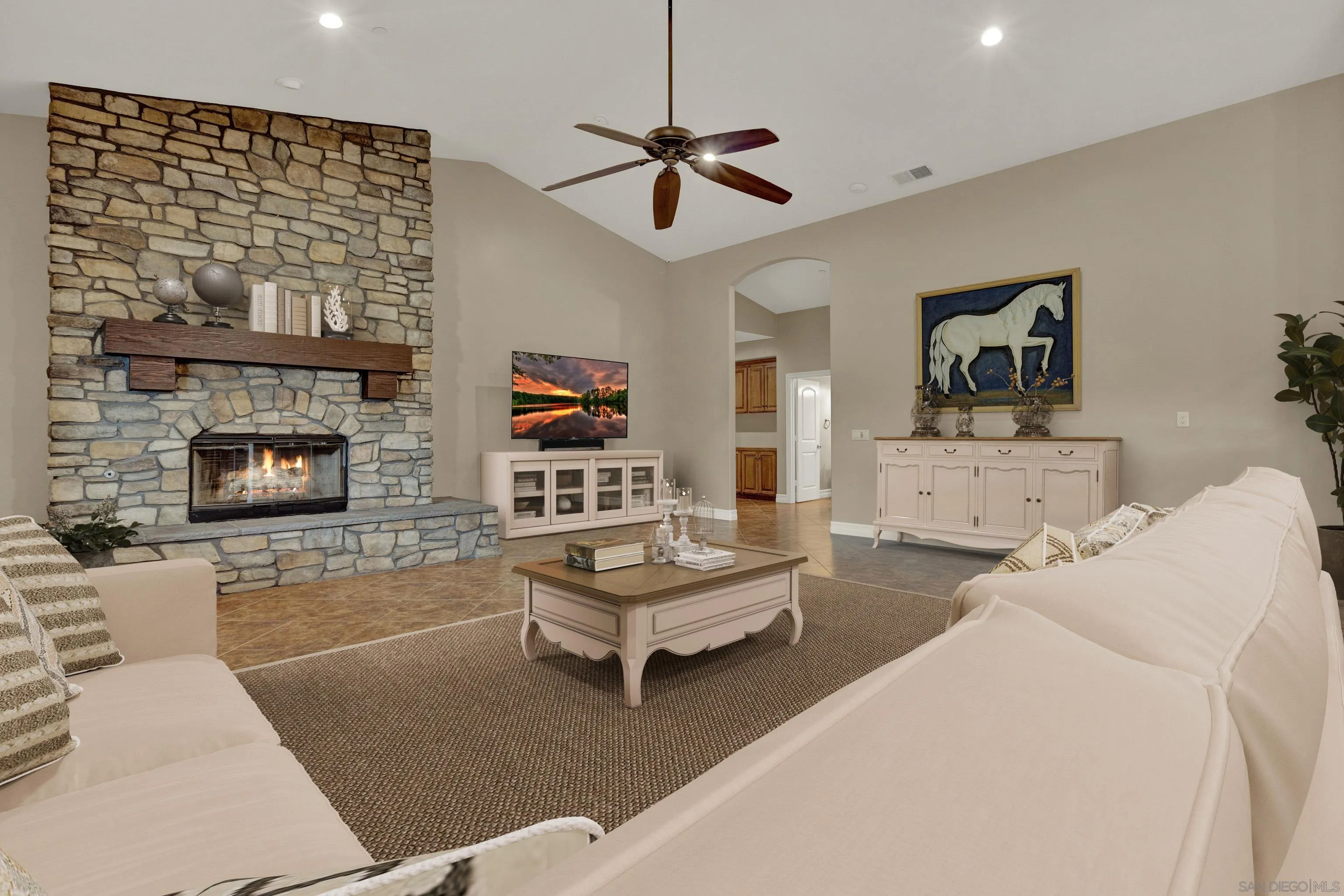 940 Heritage Ranch Road Ramona, CA 92065 - Photo 3 of 26 a living room with furniture fireplace and a flat screen tv
