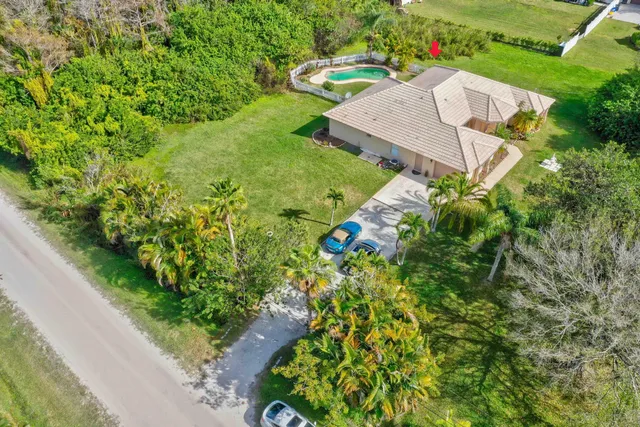 an aerial view of a house with garden space and street view