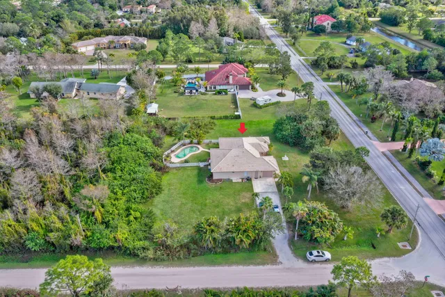 an aerial view of residential house with outdoor space and swimming pool