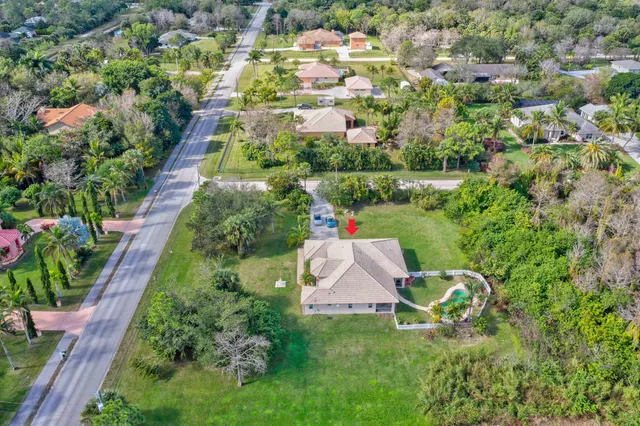 an aerial view of house with a yard and lake