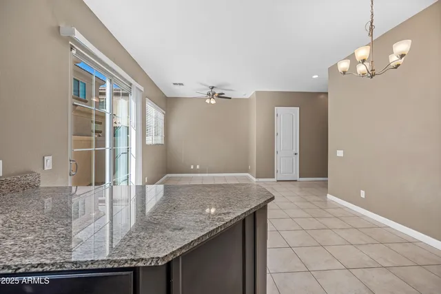 a view of a kitchen with granite countertop a sink and cabinets