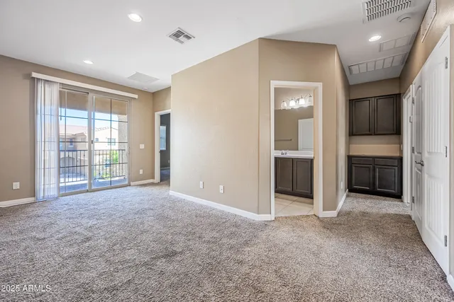 an empty room with windows and entrance