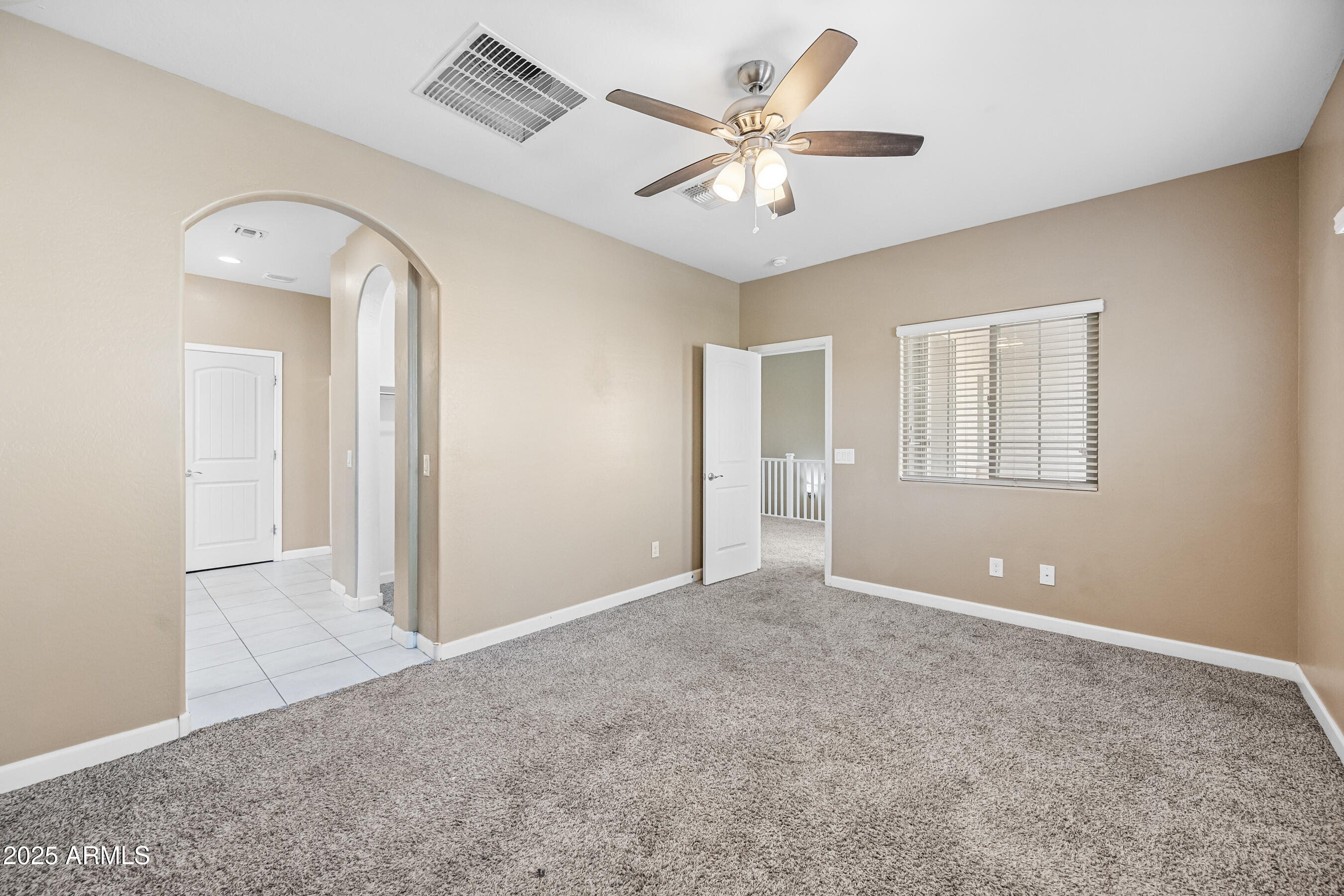 1367 South Country Club Drive, Unit 1131 Mesa, AZ 85210 - Photo 19 of 30 an empty room with a ceiling fan and a window