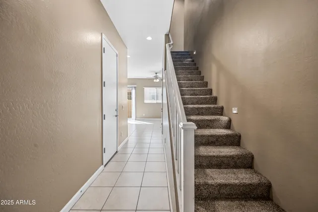 a view of a hallway with stairs and wooden floor