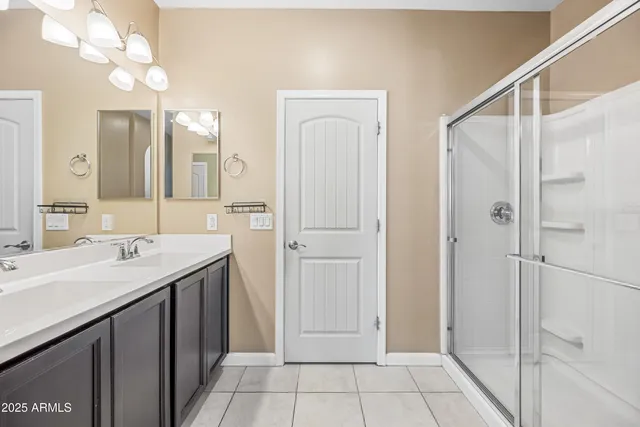a spacious bathroom with a shower sink and mirror