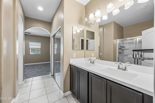 a bathroom with a sink double vanity and a mirror