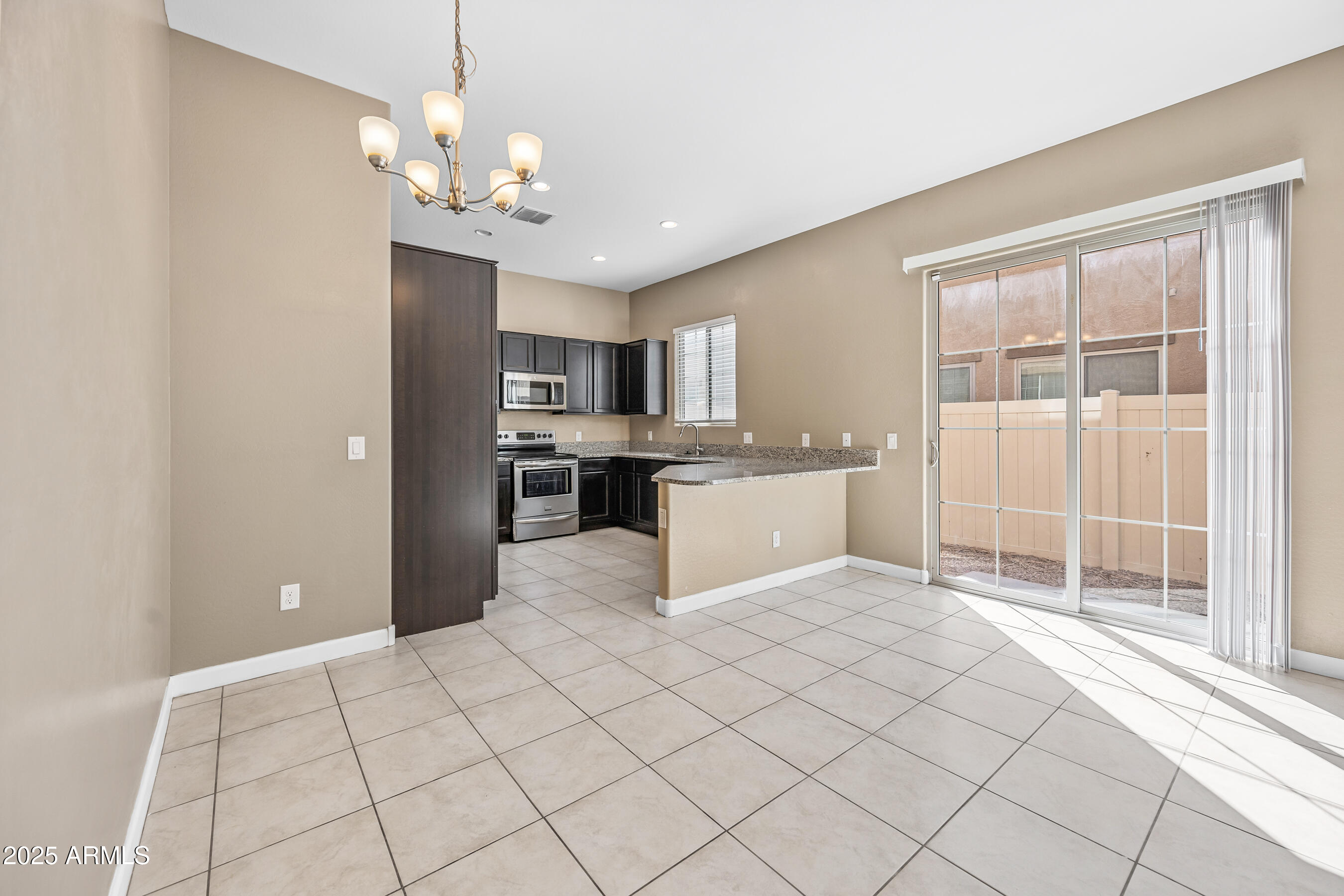 1367 South Country Club Drive, Unit 1131 Mesa, AZ 85210 - Photo 6 of 30 a view of a kitchen with microwave and cabinets