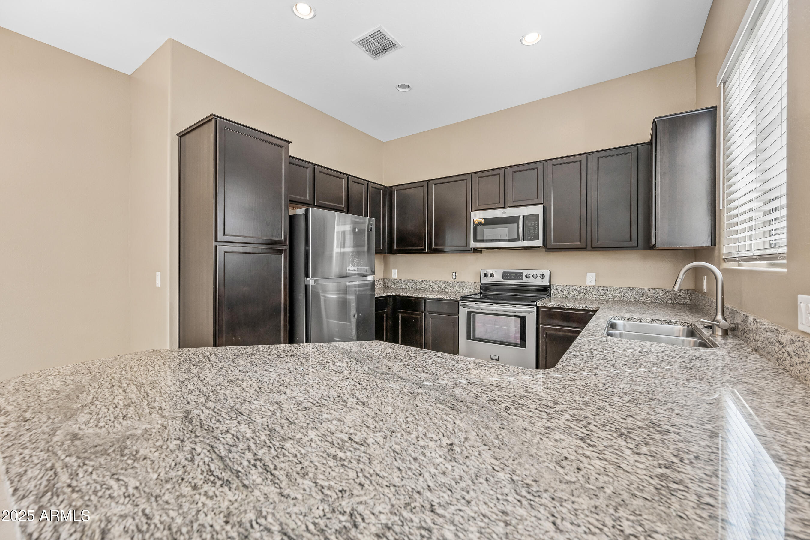 1367 South Country Club Drive, Unit 1131 Mesa, AZ 85210 - Photo 7 of 30 a kitchen with stainless steel appliances granite countertop a refrigerator sink and stove