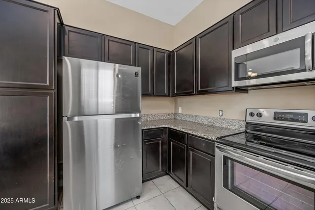 a kitchen with a refrigerator stove and microwave