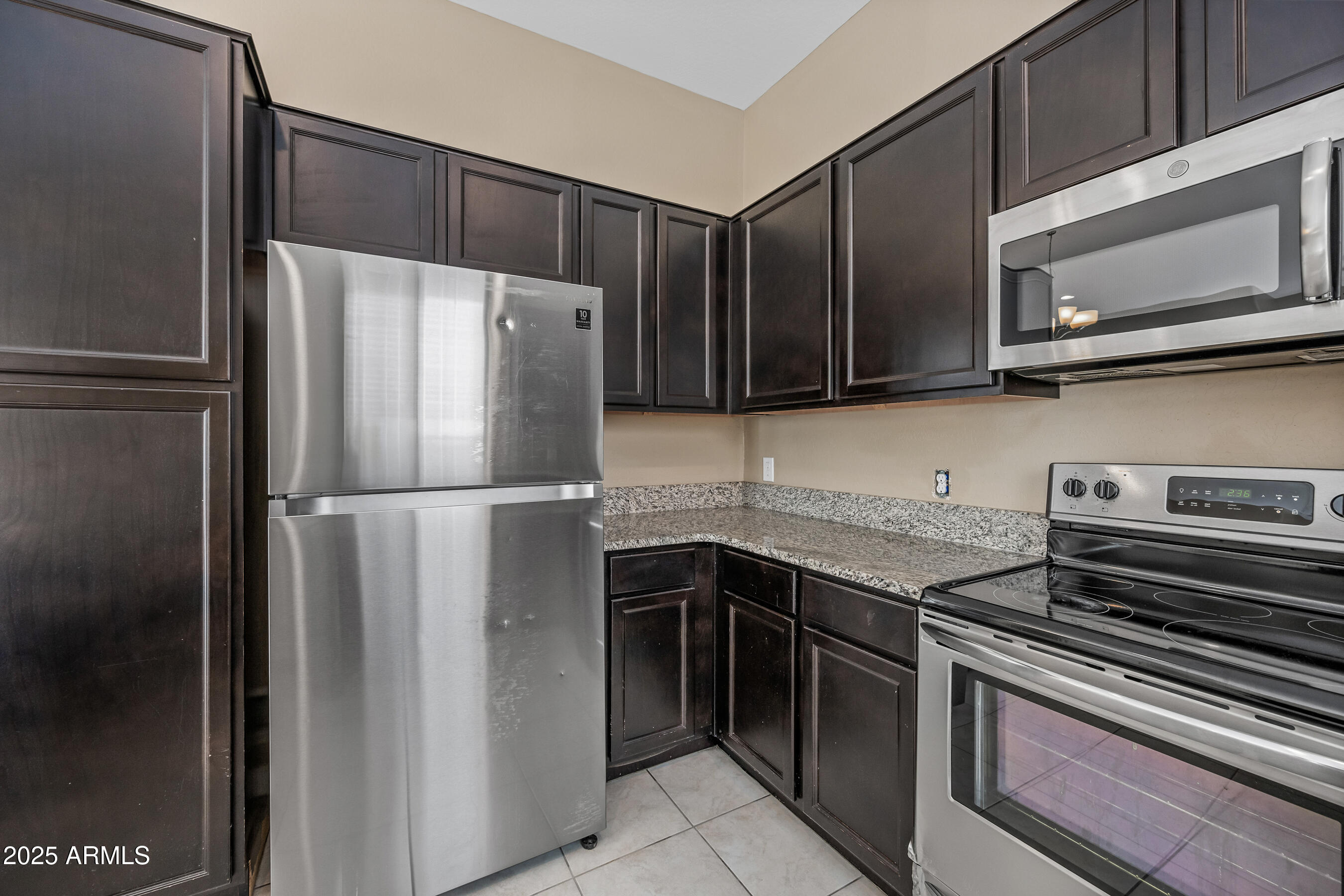 1367 South Country Club Drive, Unit 1131 Mesa, AZ 85210 - Photo 10 of 30 a kitchen with a refrigerator stove and microwave
