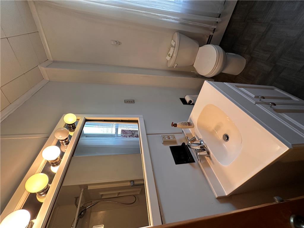 5128 3rd Street Whitehall, PA 18052 - Photo 23 of 26 This bathroom features a contemporary vanity with an integrated sink and bright vanity lighting.