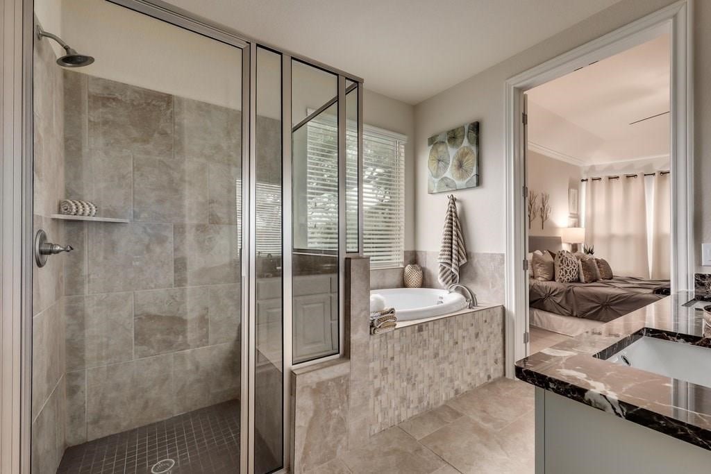 10825 Ballard Path Austin, TX 78717 - Photo 23 of 39 a bathroom with a granite countertop sink a mirror and shower