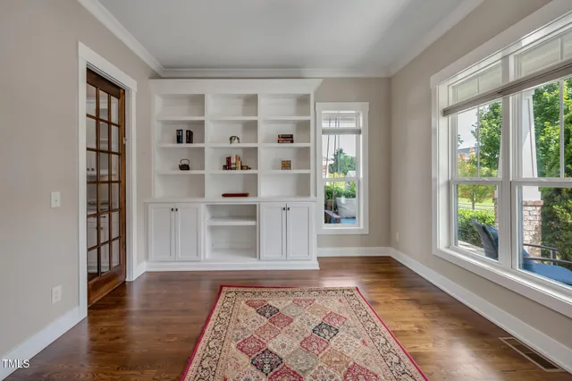 a living room with furniture a fireplace and a large window