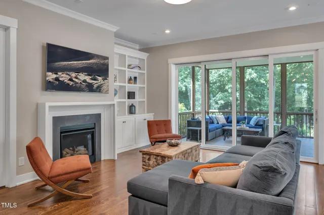 a kitchen that has a table chairs stainless steel appliances and wooden floor