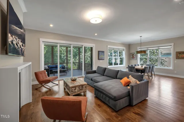 a kitchen with stainless steel appliances granite countertop a sink a stove and a wooden floors